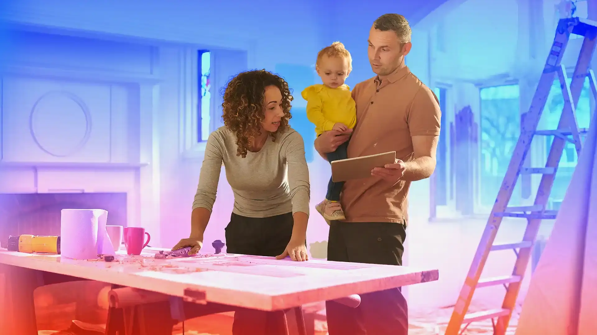 young couple with their child in their under construction home