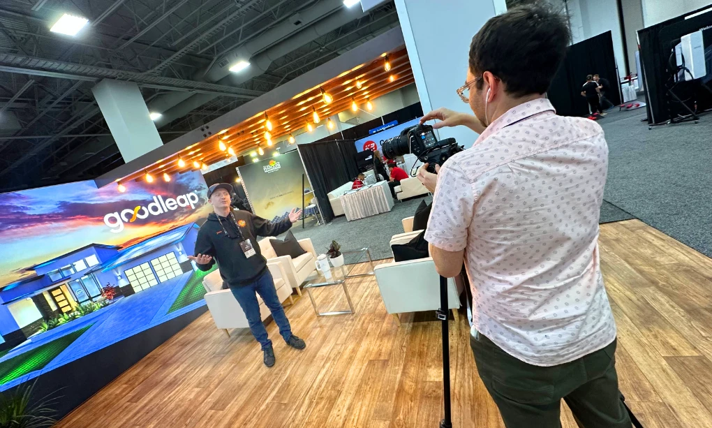 Sales professional talking to a camera being operated by another person