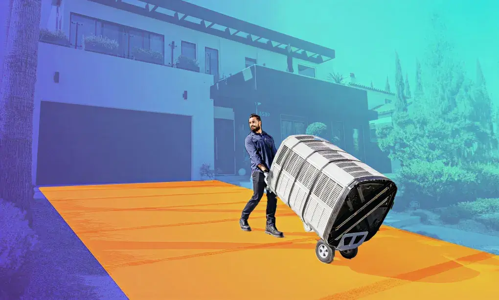 HVAC professional with an HVAC unit on a hand truck
