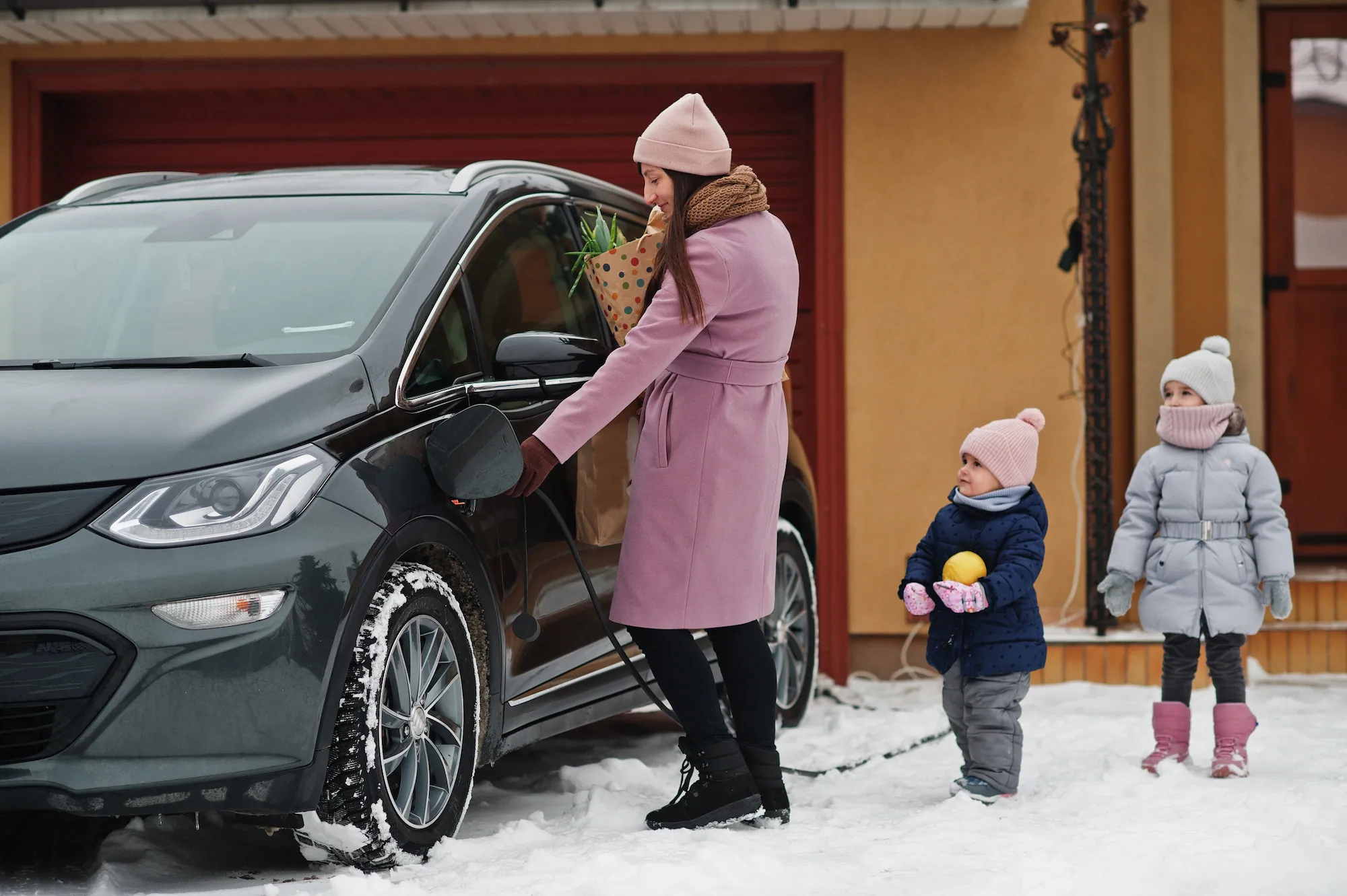 Family charging their EV with home battery