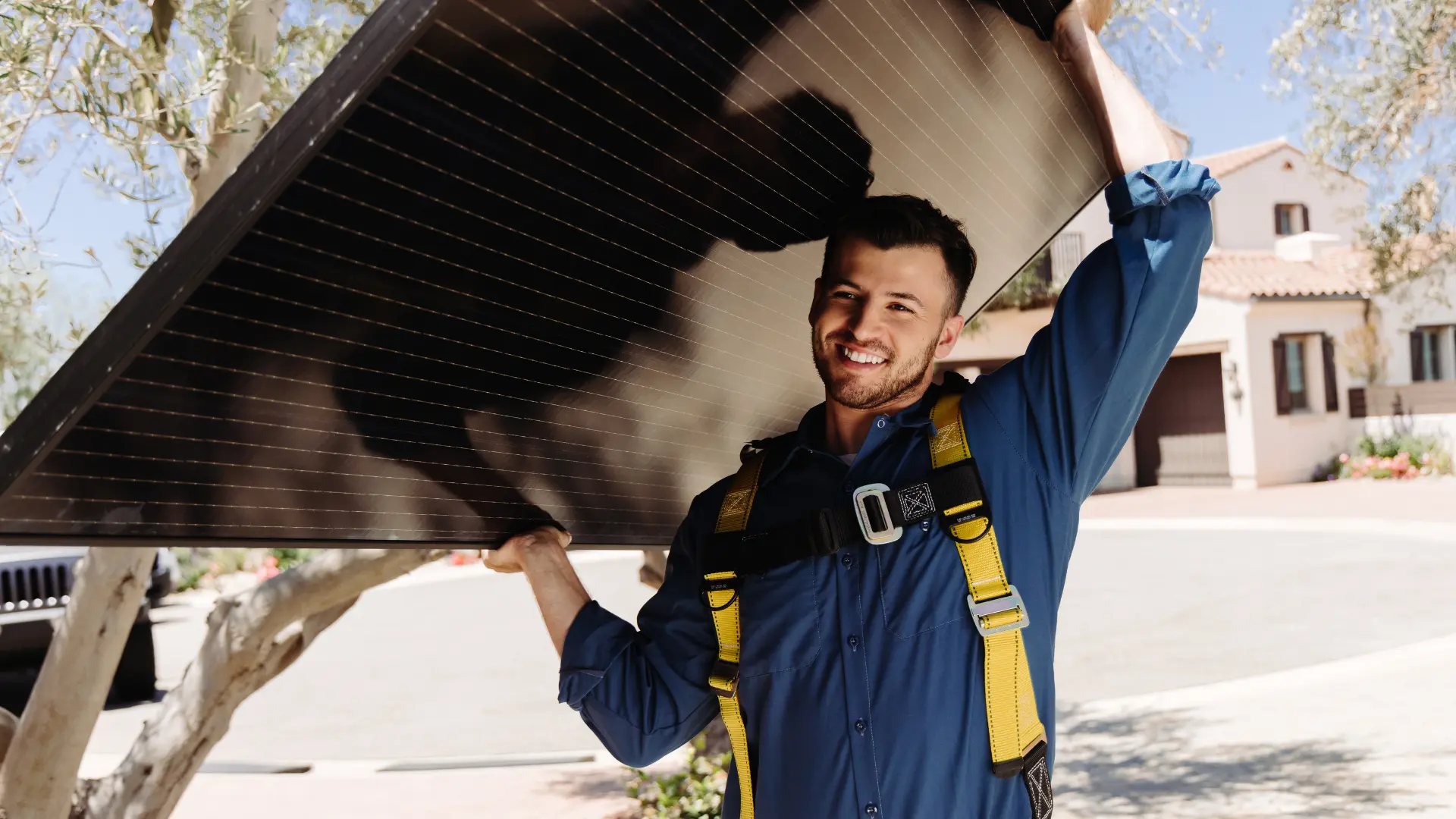 Solar installer carrying a solar panel